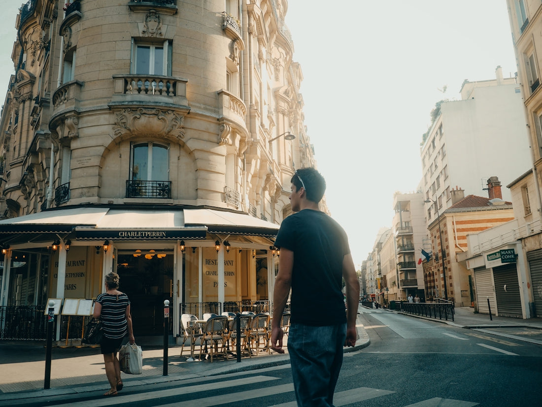 Man walks down a sunny european street.