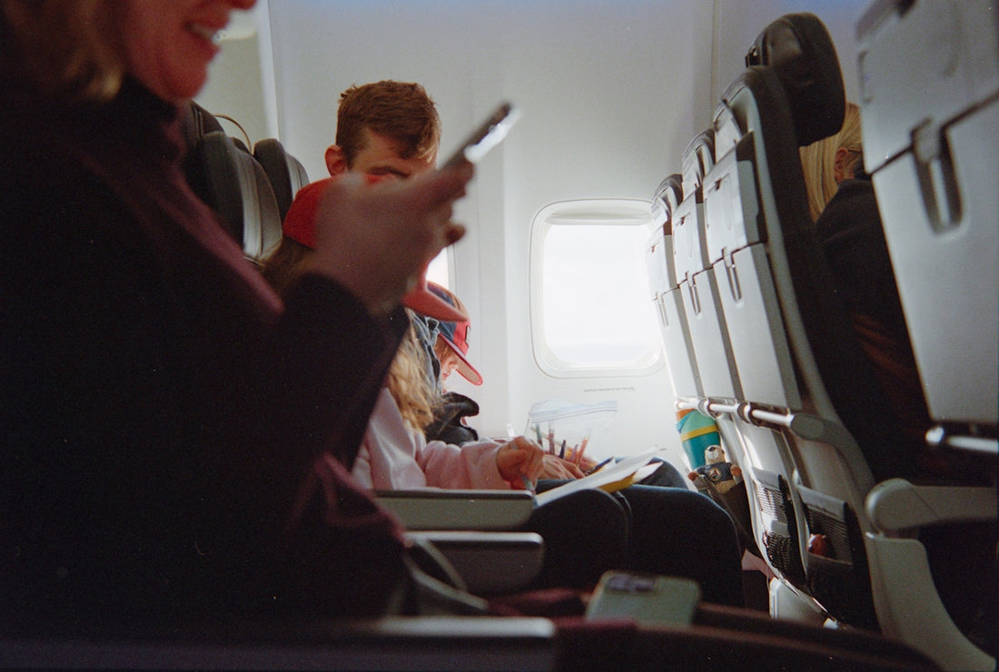 People traveling on an airplane during daytime.